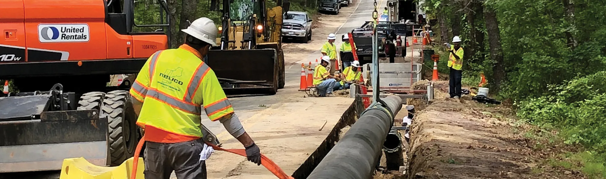 Working on large pipeline in a ditch alongside road