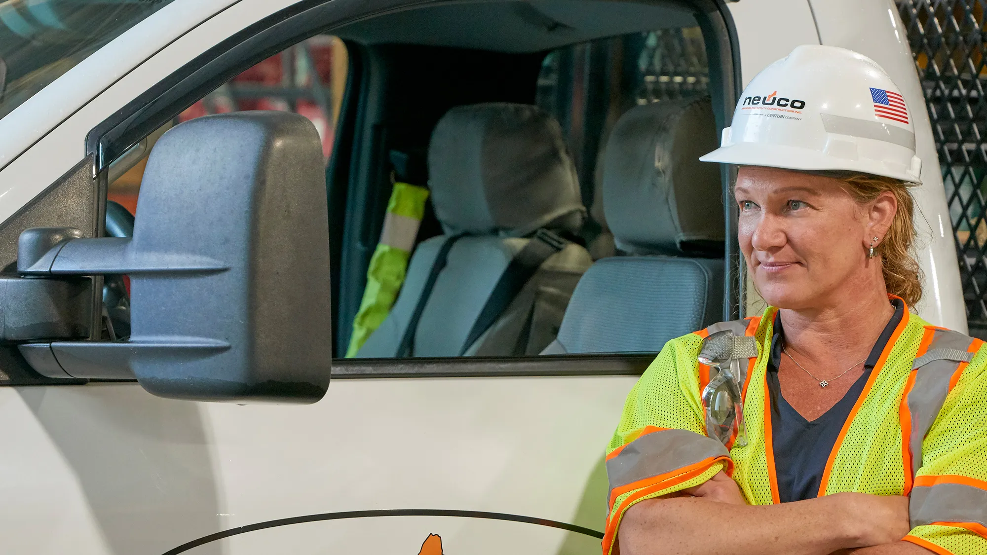 Neuco woman leaning against truck confidently