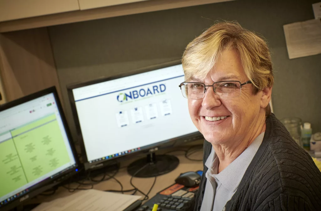 Smiling woman at computer desk