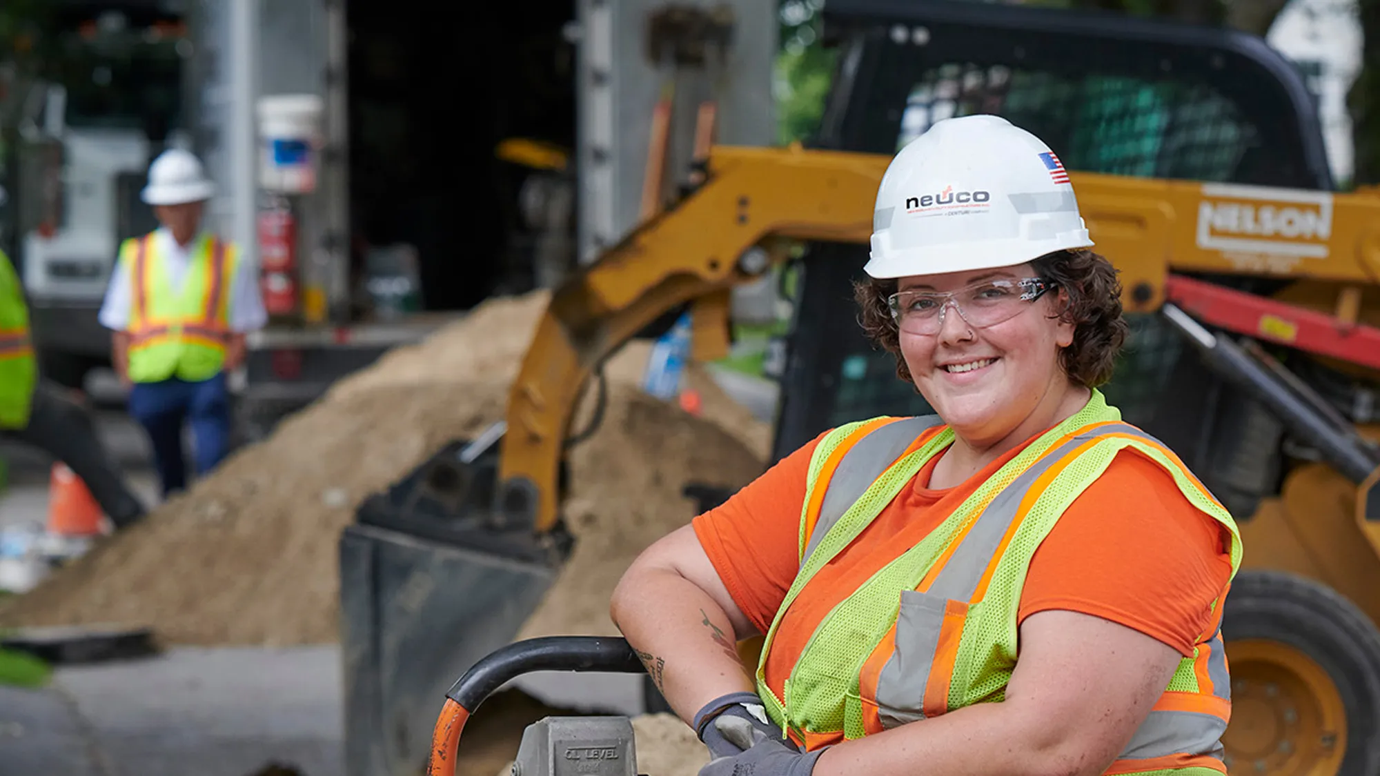 Smiling Neuco employee in hard hat on job site